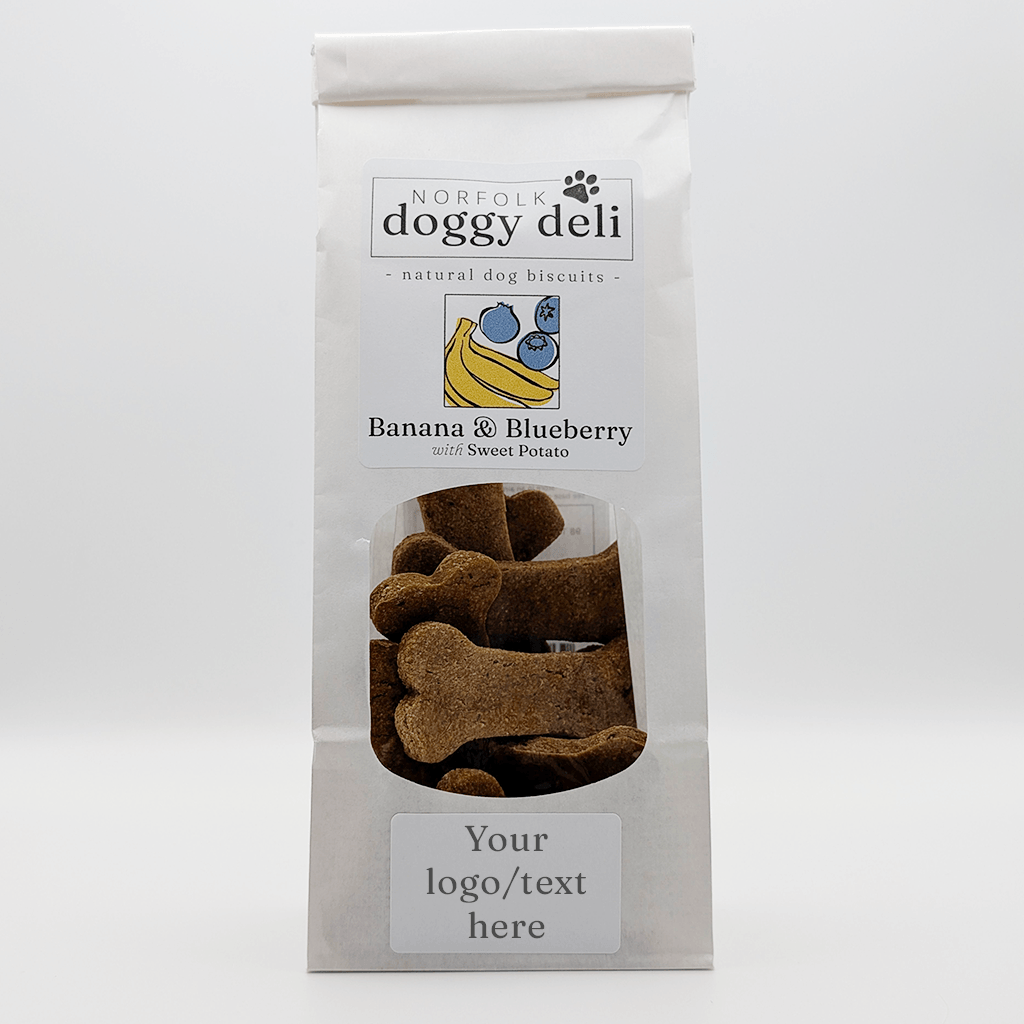 Package of Norfolk Doggy Deli banana and blueberry dog biscuits on a white background
