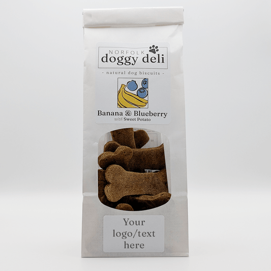 Package of Norfolk Doggy Deli banana and blueberry dog biscuits on a white background