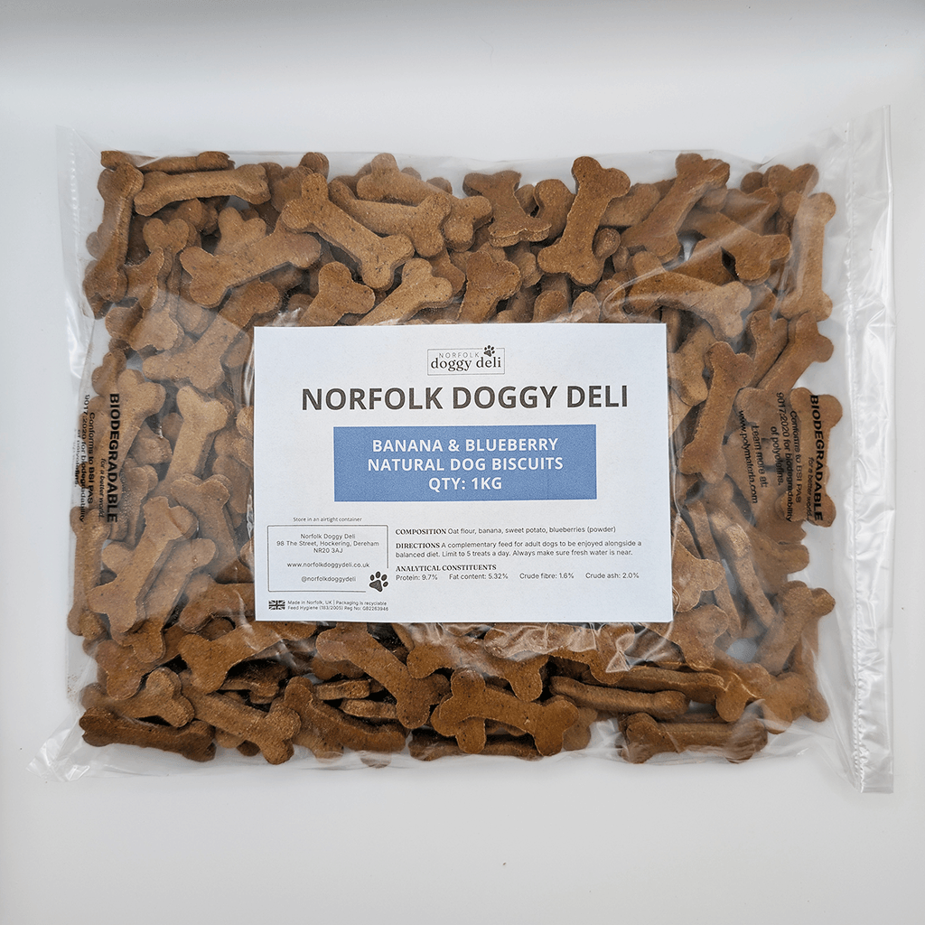 Packaged dog biscuits with a label for Norfolk Doggy Deli on a white background