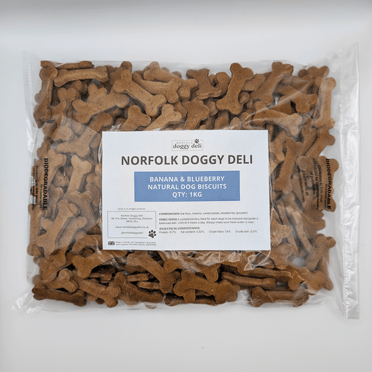 Packaged dog biscuits with a label for Norfolk Doggy Deli on a white background