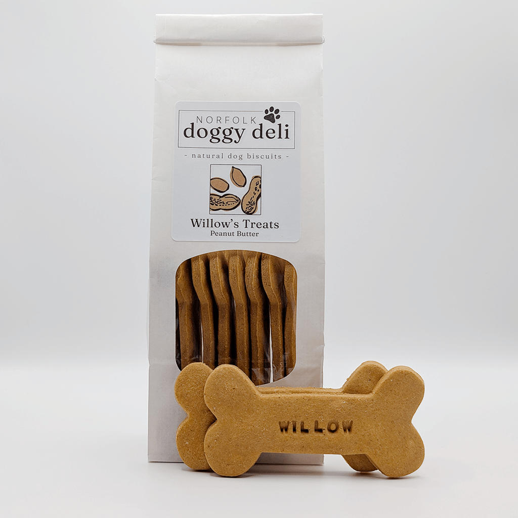 Dog treats with packaging labeled 'Norfolk Doggy Deli' on a white background